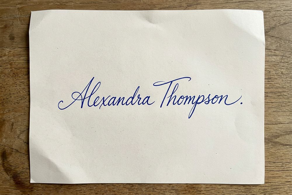 Blue ink signature on paper